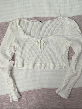 White long sleeve top with lace trim and bow detail